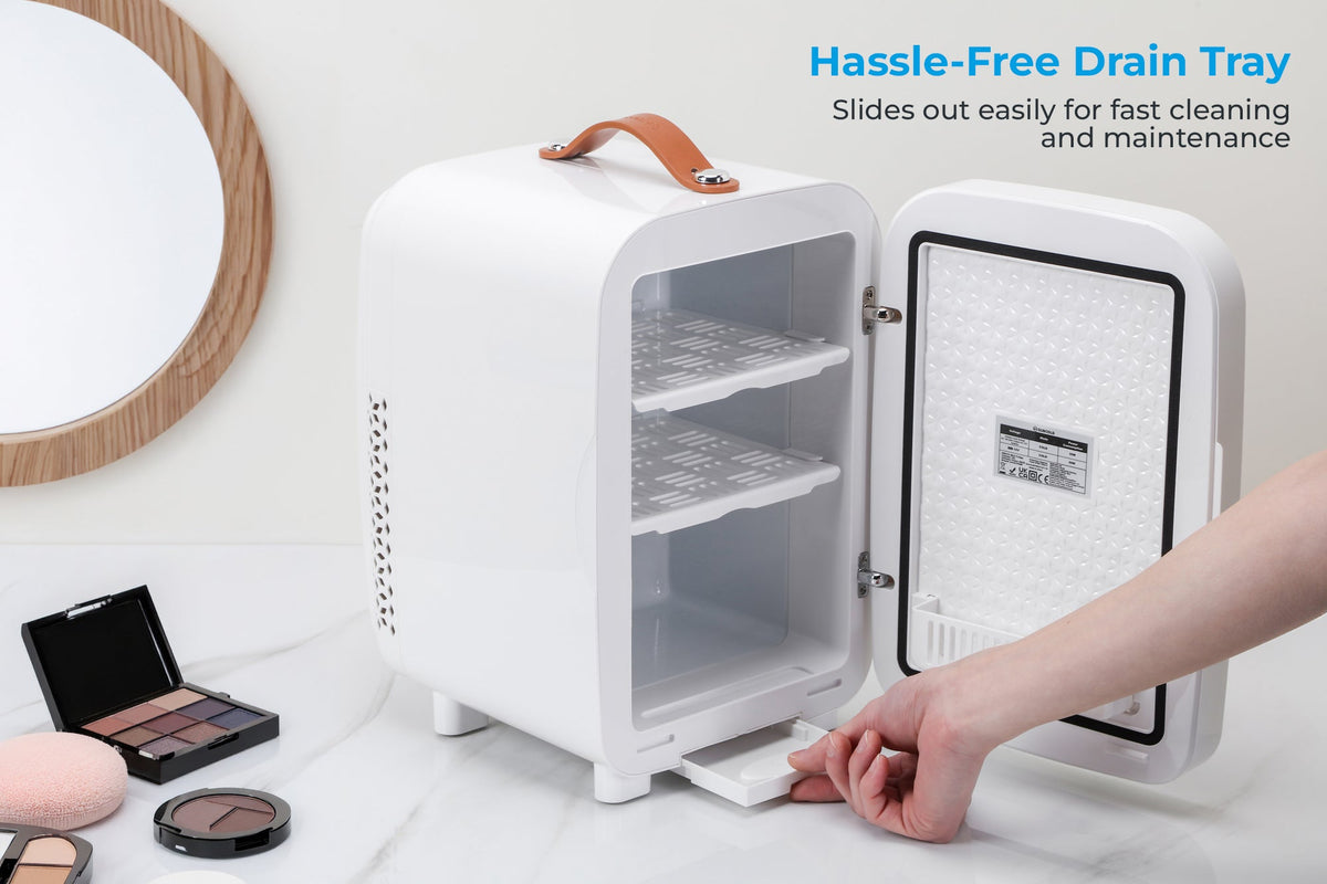 White mini fridge with door open; hand removing tray at bottom interior
