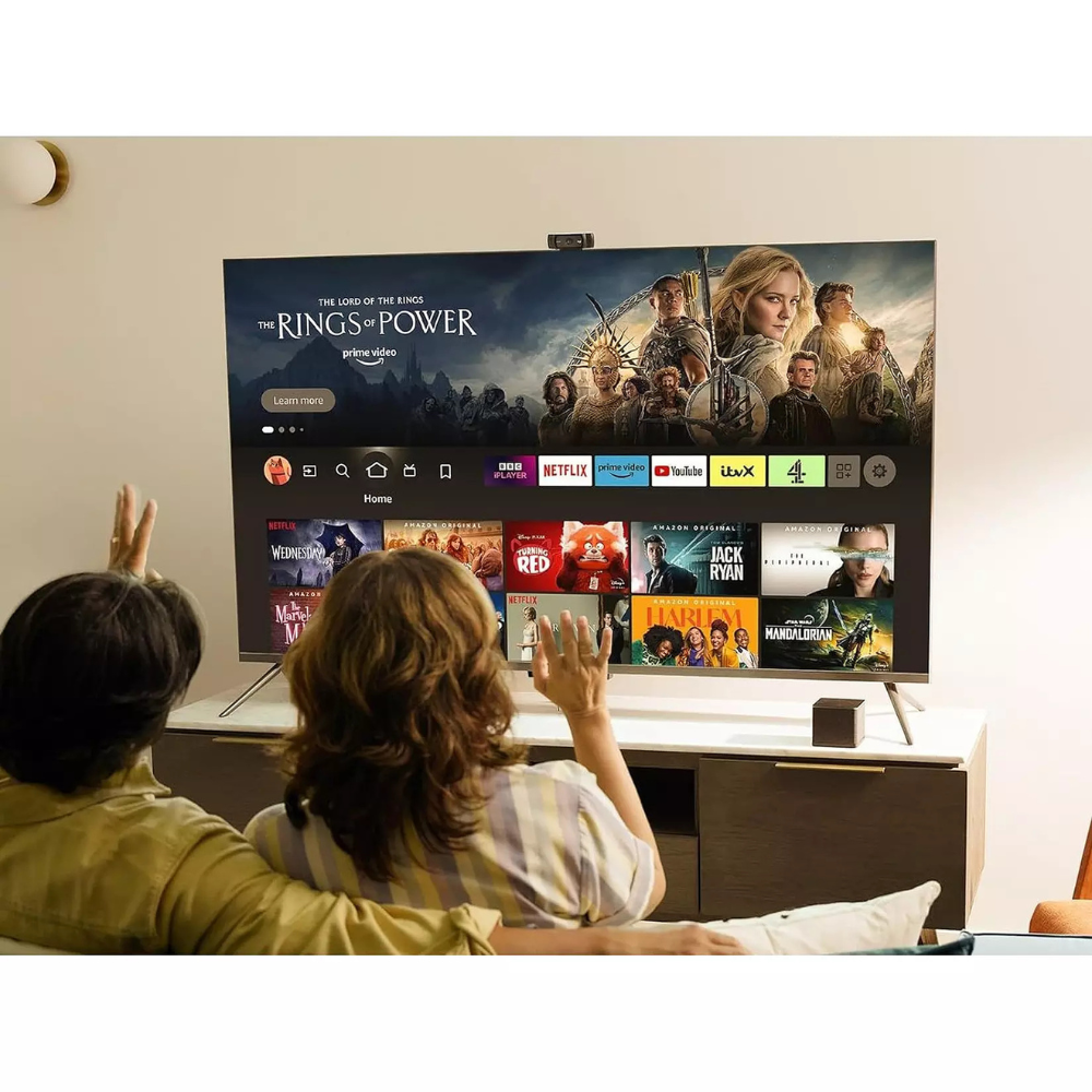 LED TV displaying streaming content as viewers watch from sofa