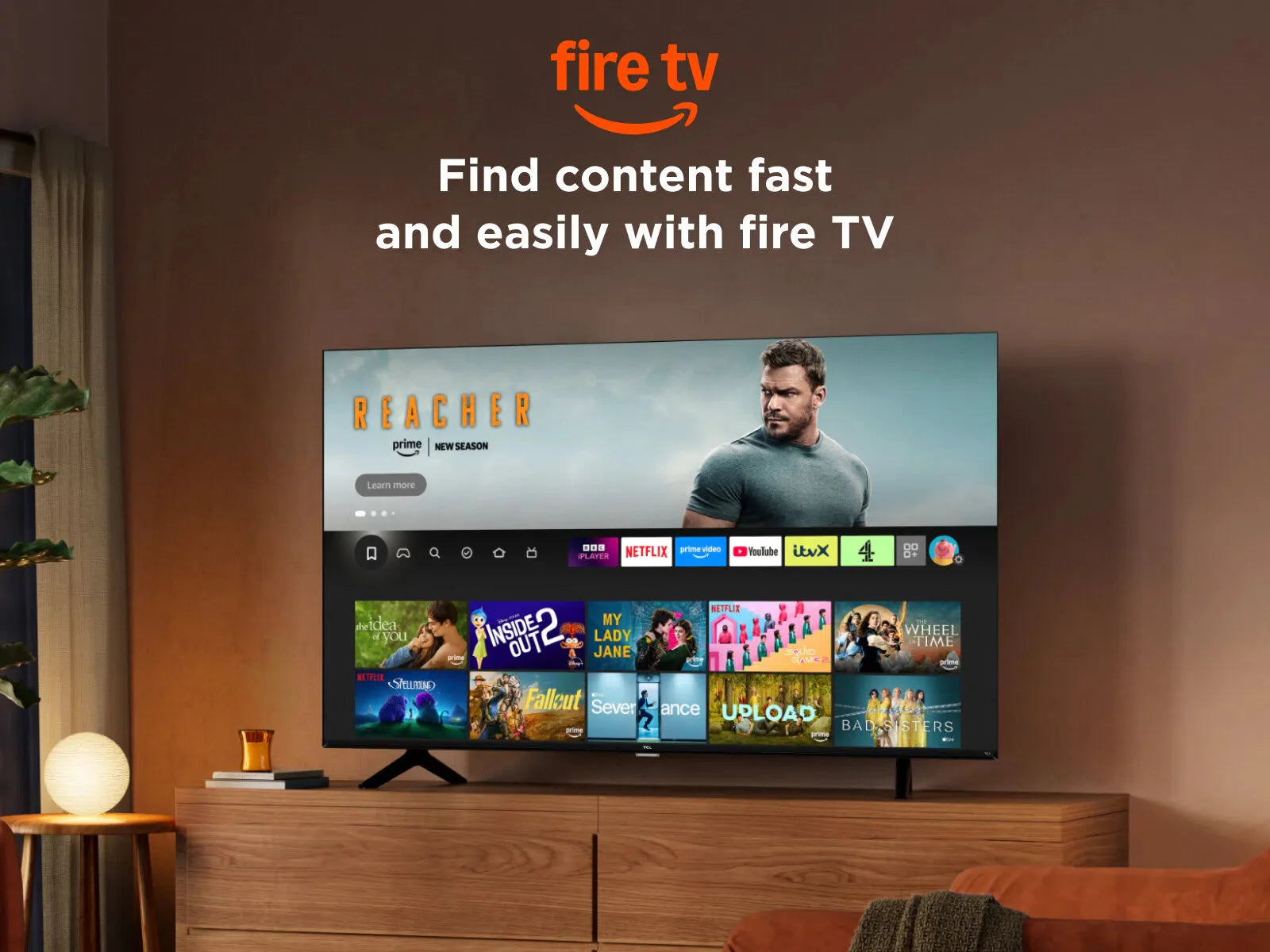 Black TV on a wooden console displaying Fire TV home screen