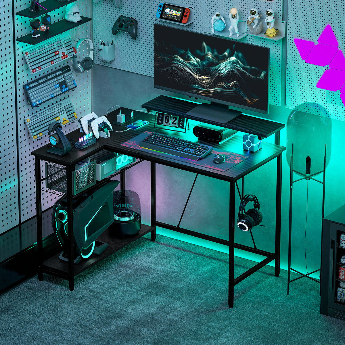 Black L-shaped gaming desk with monitor, keyboard, and vivid RGB LED accents.