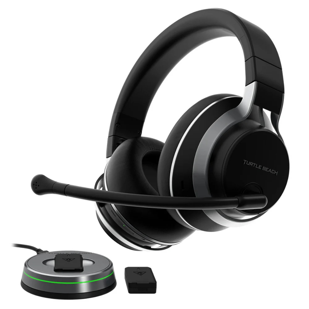 Black over-ear gaming headset with boom mic, shown with charging dock and adapter