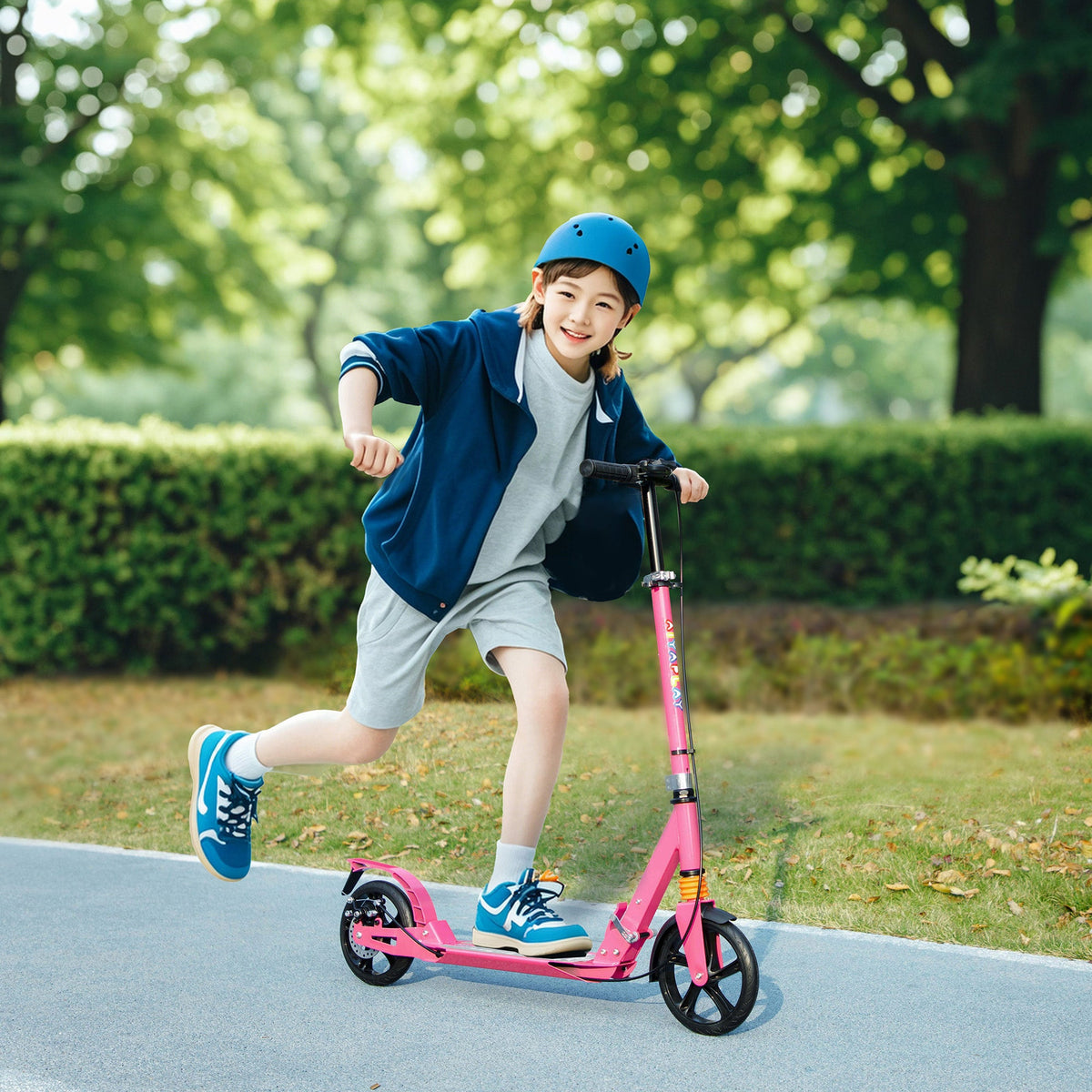 Pink kids kick scooter with black wheels and kick deck, outdoor on road