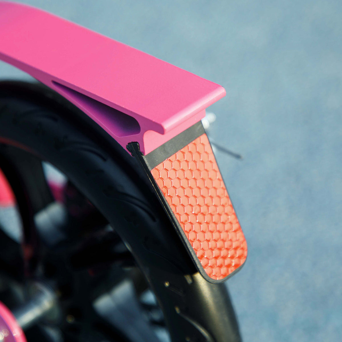 Pink scooter front fender with textured orange reflector panel