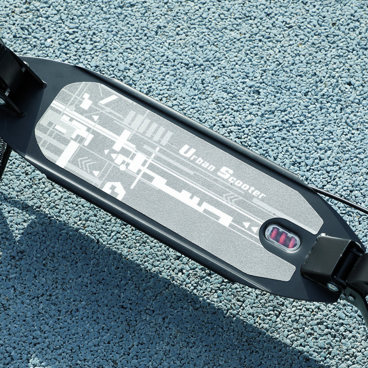 Black scooter deck with patterned grip surface and red brake light detail