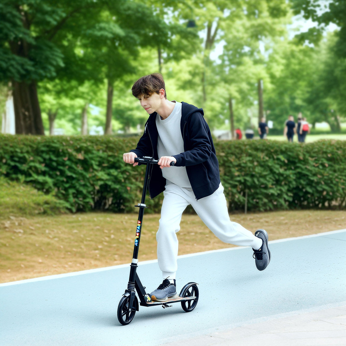 Child riding a black kids foldable kick scooter with graphic deck