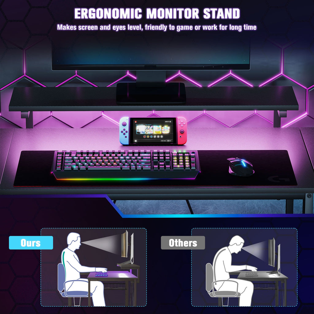 Black gaming desk with ergonomic monitor stand and RGB keyboard and mouse setup.