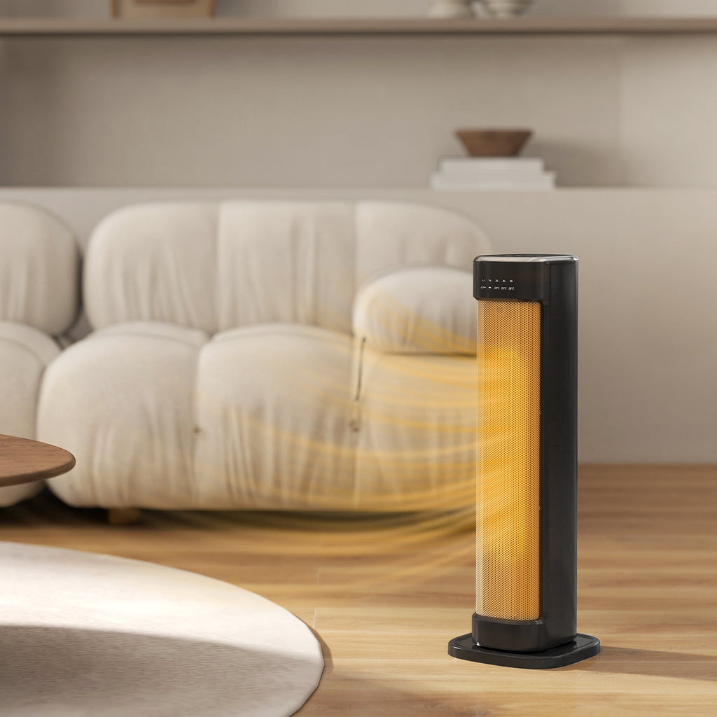 Black ceramic tower electric heater standing near sofa with glowing heating element