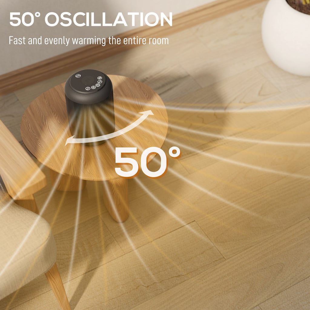 Black ceramic electric heater on table with glowing amber heating core