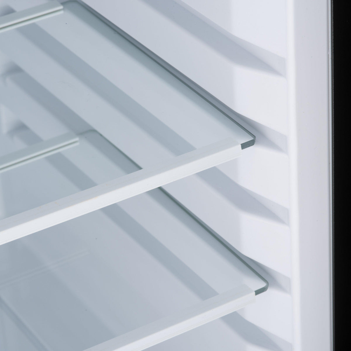 Mini bar fridge interior with white wire bottle shelves