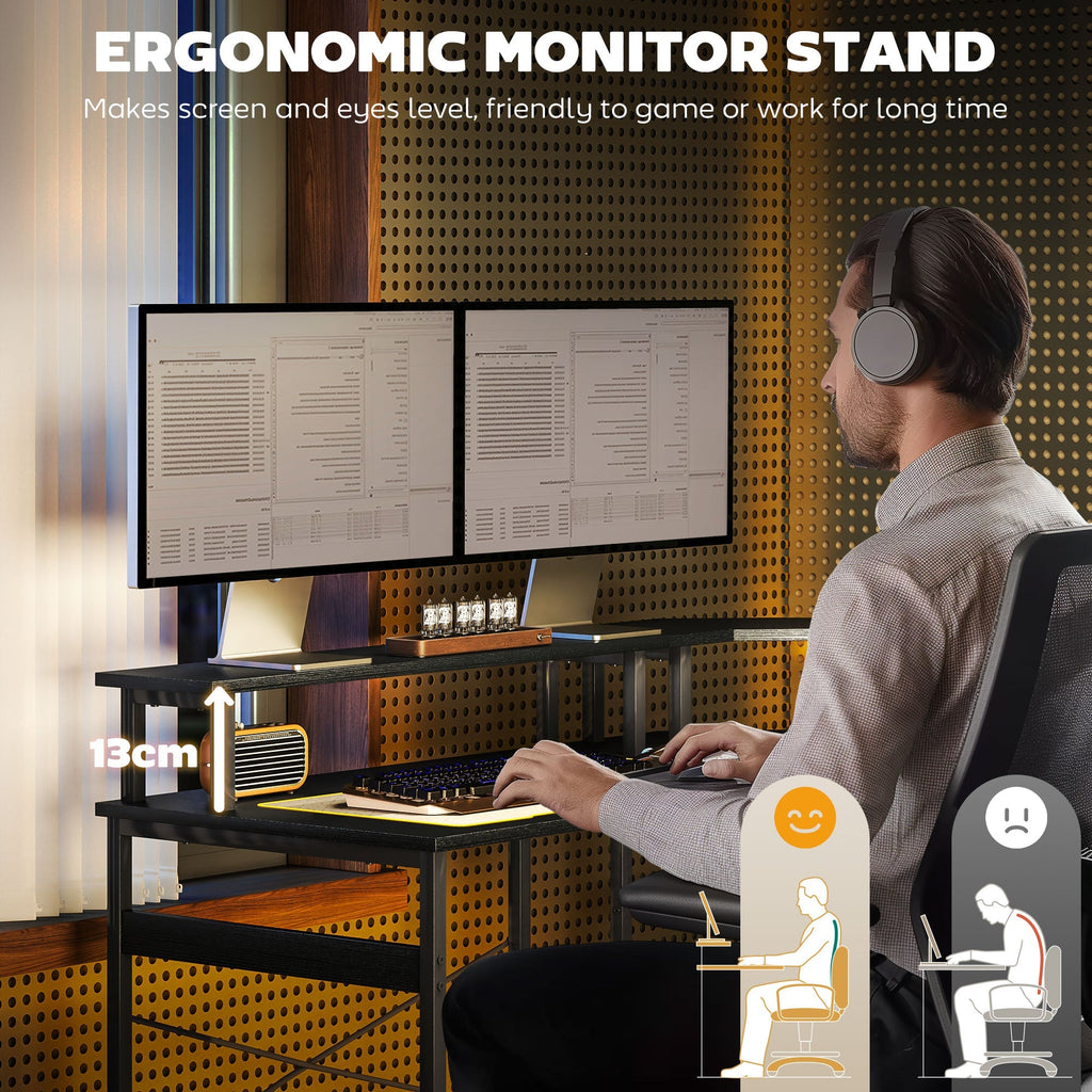 Black L-shaped desk with monitor setup and LED-lit workspace surface