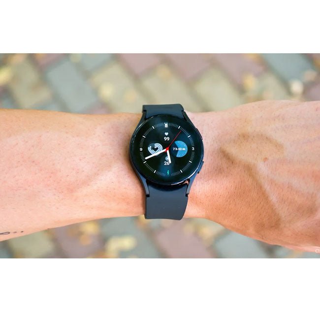 Blue smartwatch on wrist with dark round display and colorful activity-style watch face