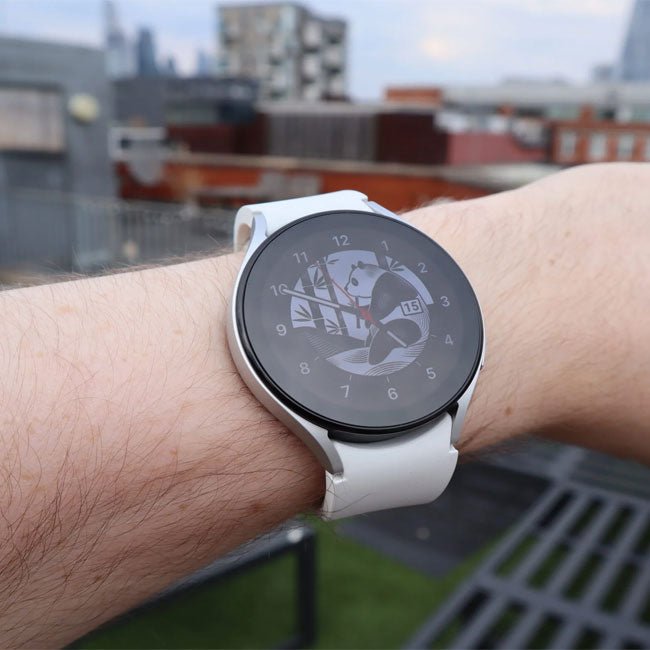 Samsung Galaxy Watch 5 44mm smartwatch on wrist with white band and black compass-style face