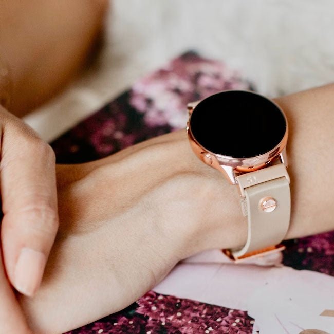 Refurbished smartwatch with rose gold case and light pink strap on wrist