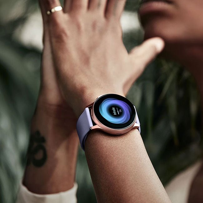 Refurbished smartwatch on wrist with dark strap and blue-toned round watch face