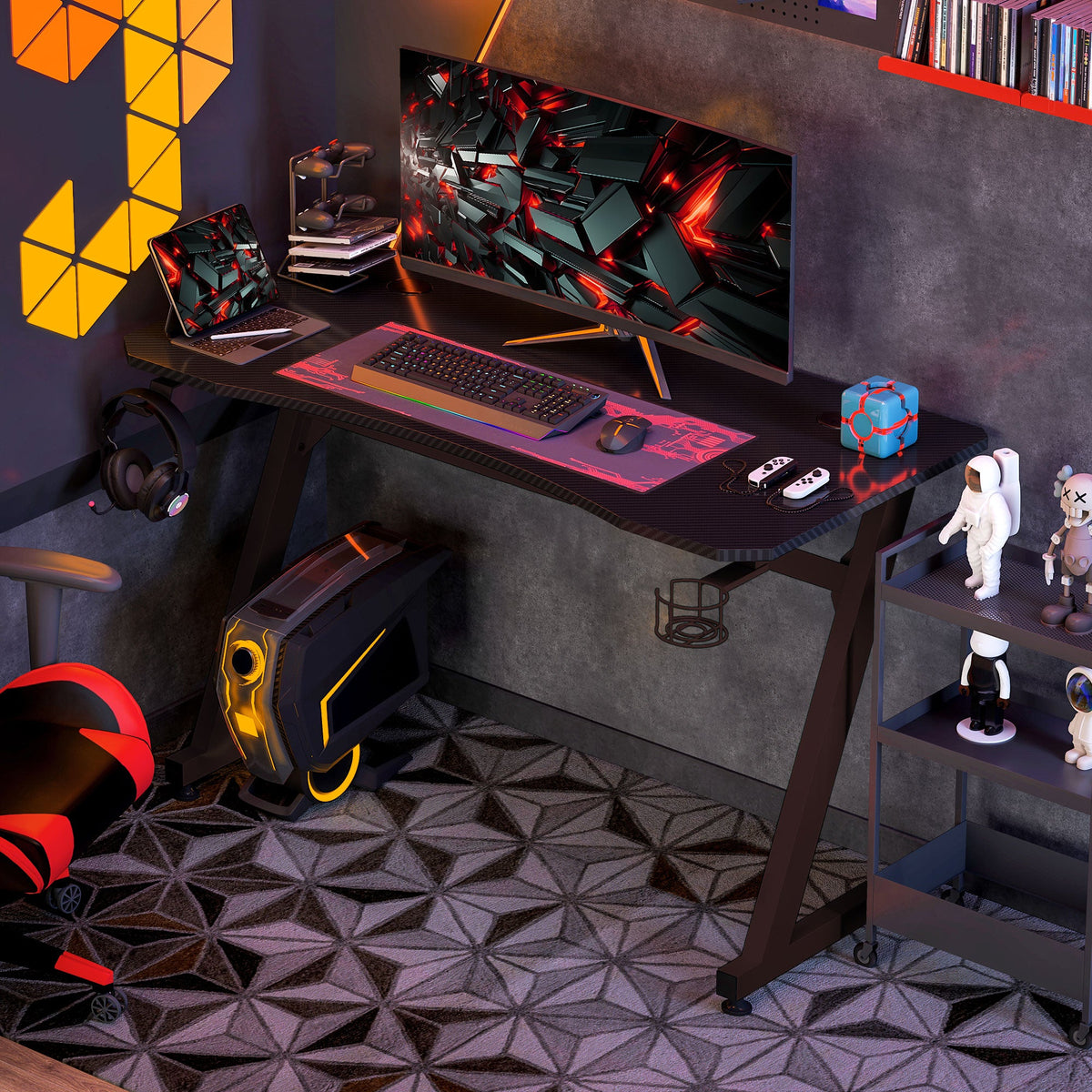 Black gaming desk with monitor stand, keyboard area, cup holder, and headphone hook