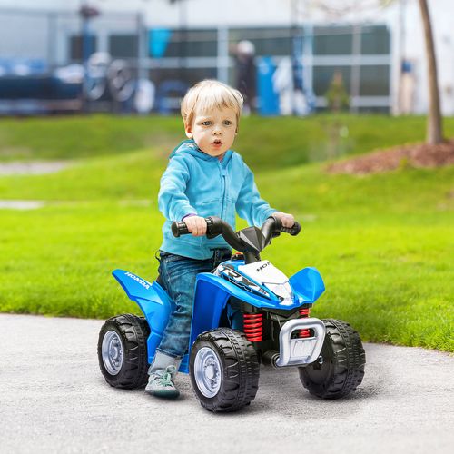 Blue kids electric quad bike with a toddler riding on a paved path