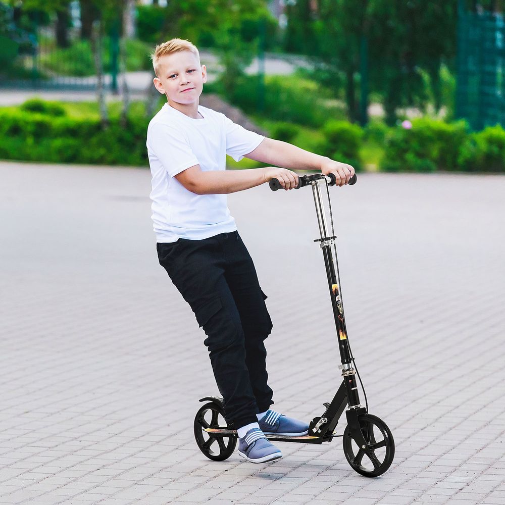 Kids kick scooter with black frame, large wheels, and handlebar, ridden by child