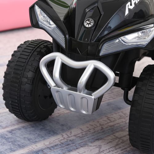 Close-up of silver front guard and black tires on a toddler quad ride-on car