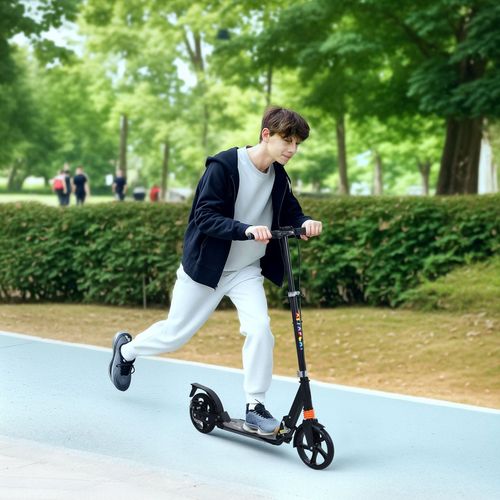 Kids kick scooter in black with colorful stem, ridden by child on an outdoor path