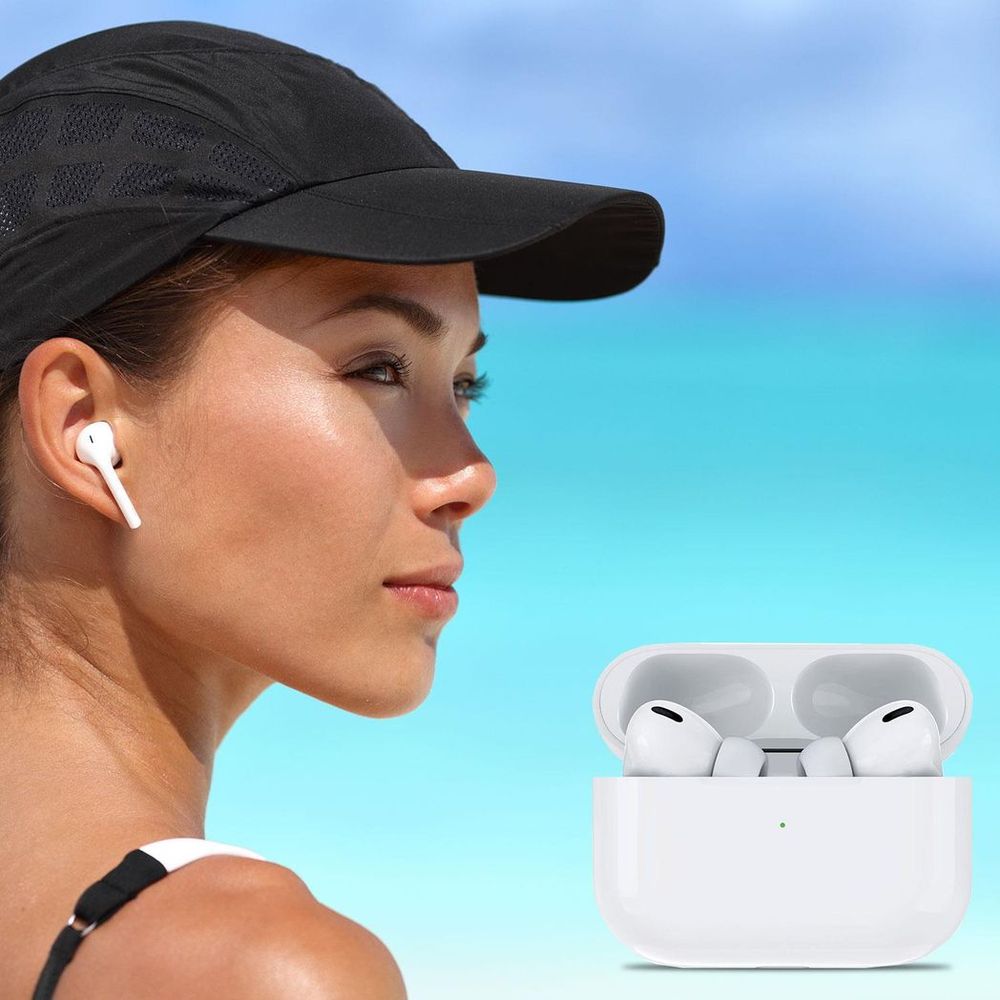 White wireless earbud on ear with charging case in background
