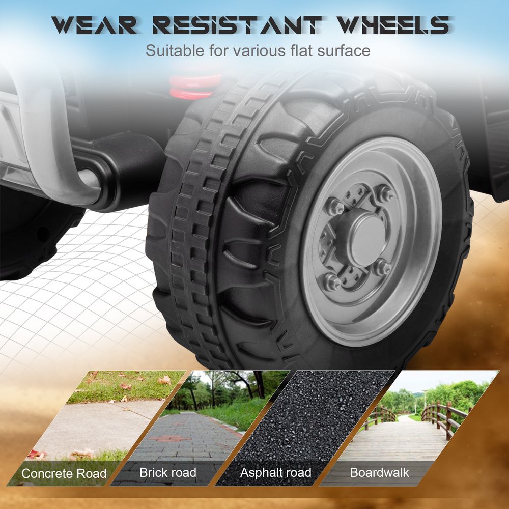 Kids electric quad bike front wheel and tire tread with silver rim close-up