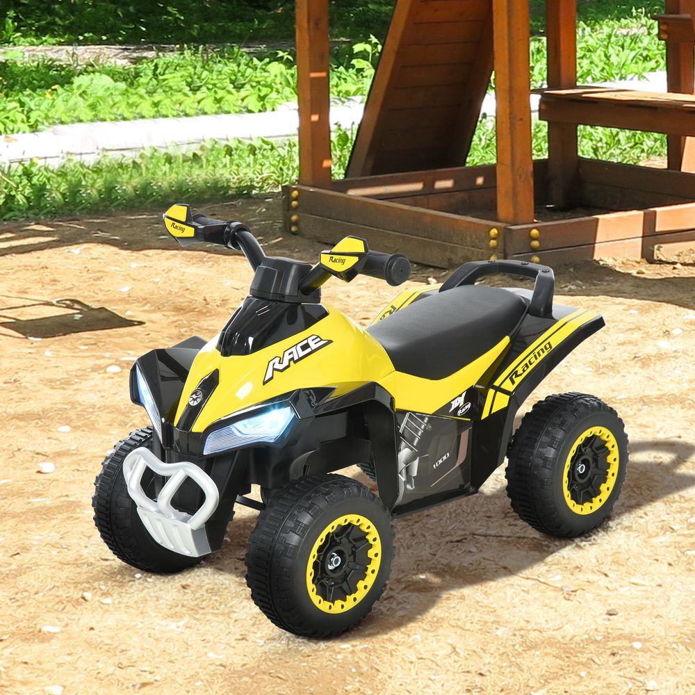 Yellow and black foot-to-floor toddler quad ride-on with front light