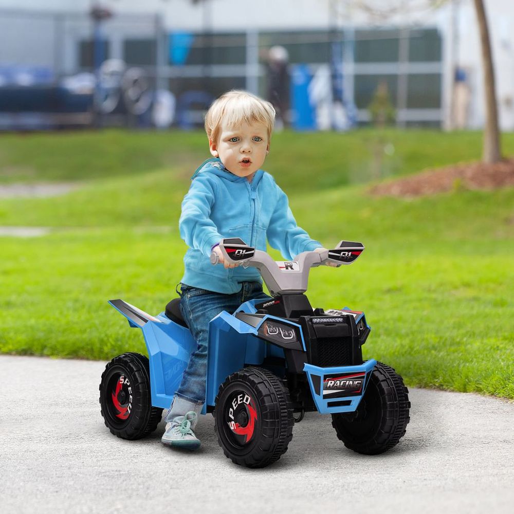 Blue kids electric quad bike with black seat and red wheels; child seated outdoors