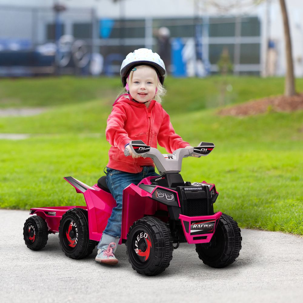 Pink electric quad ride-on with black seat and handlebar, with child onboard