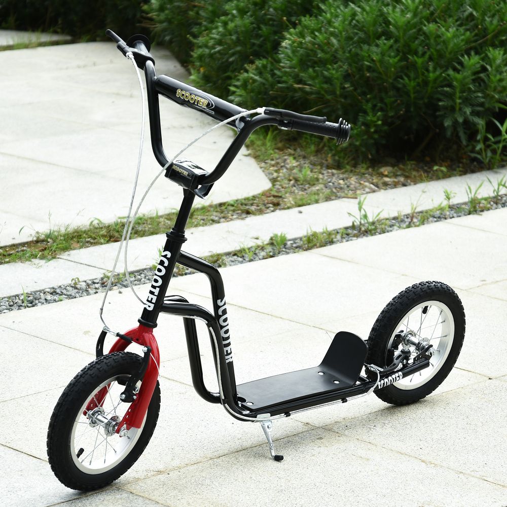 Kids kick scooter with black frame, red front wheel, padded deck and handlebar