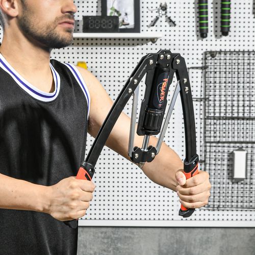 Person gripping black scooter handles with orange-red accents in an indoor workshop