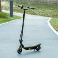 Black folding electric scooter with front LED headlight and textured foot deck