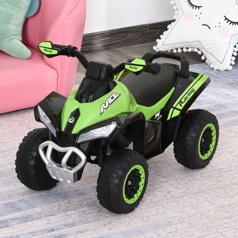 Green and black toddler ride-on quad car with LED-style headlights and front bumper