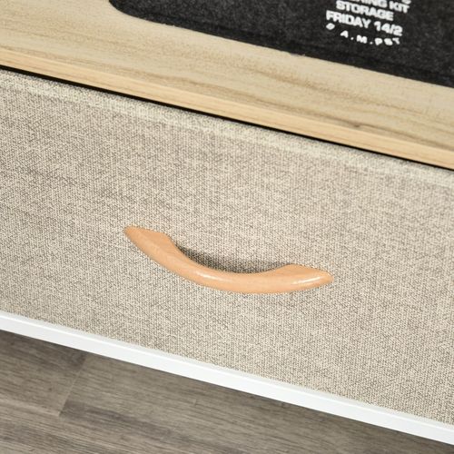 Close-up of gray linen drawer front with curved wooden handle on a white TV stand