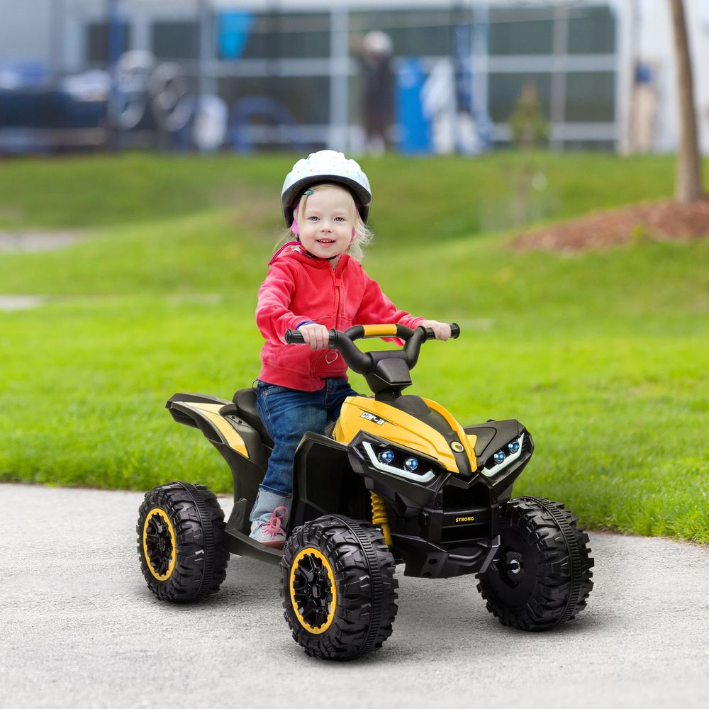 Kids yellow electric quad bike with black tires and blue LED headlights, child rider