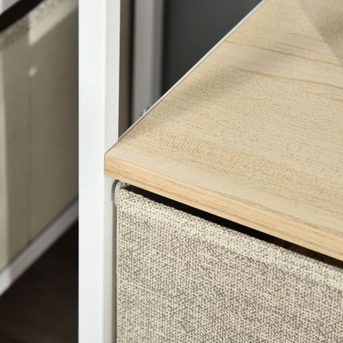 Close-up of TV stand corner: light wood tabletop edge and gray linen drawer front with white frame