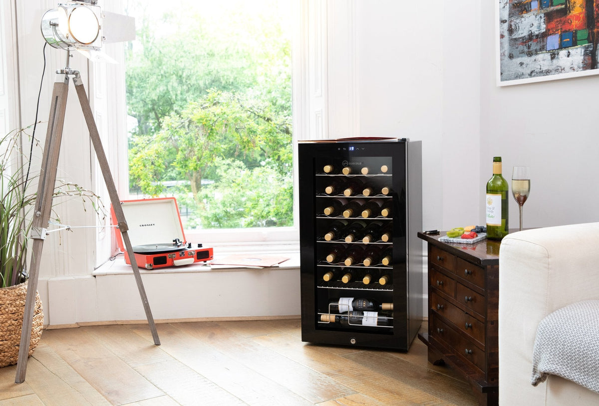 Freestanding black wine cooler with glass door, LED-lit interior, and bottle storage