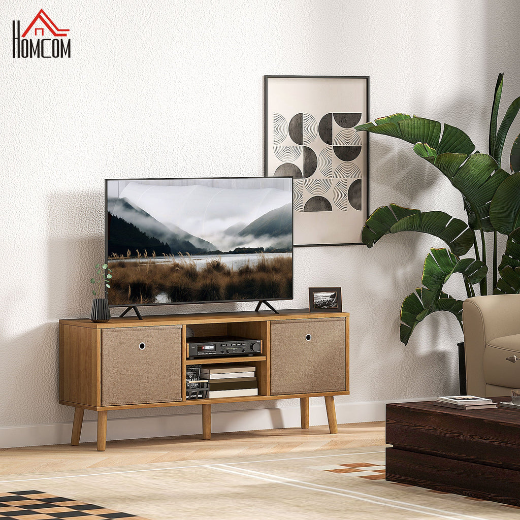 Brown TV cabinet with fabric doors and open media shelf, set on light wood legs in living room