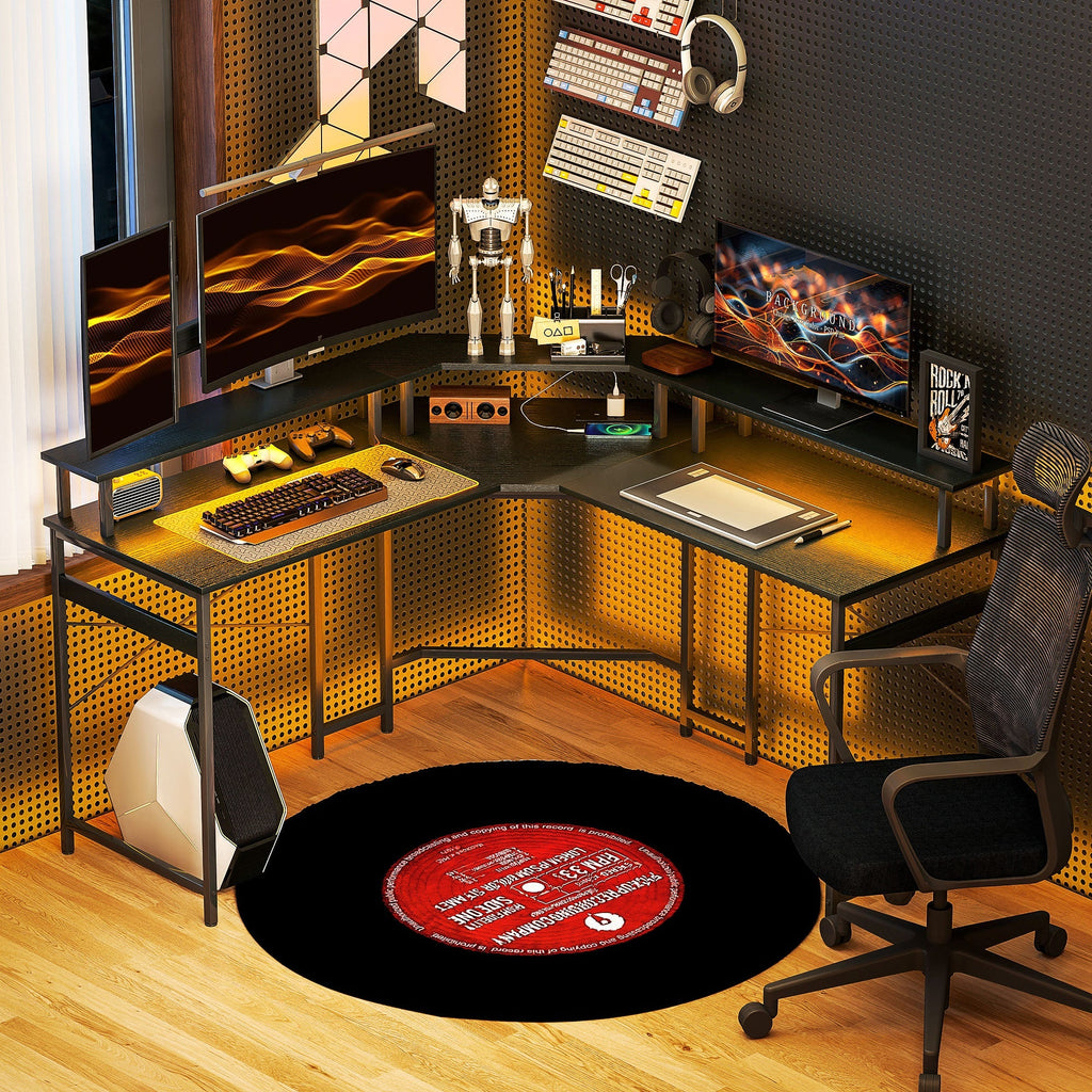 Black L-shaped desk with LED accents, dual surfaces, metal legs, and crossbars